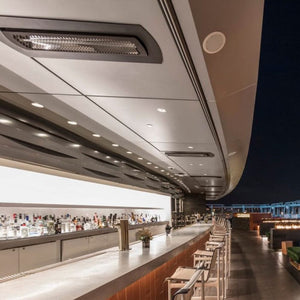 Black bromic tungsten smart-heat black electric patio heater flush mounted at a bar outdoors
