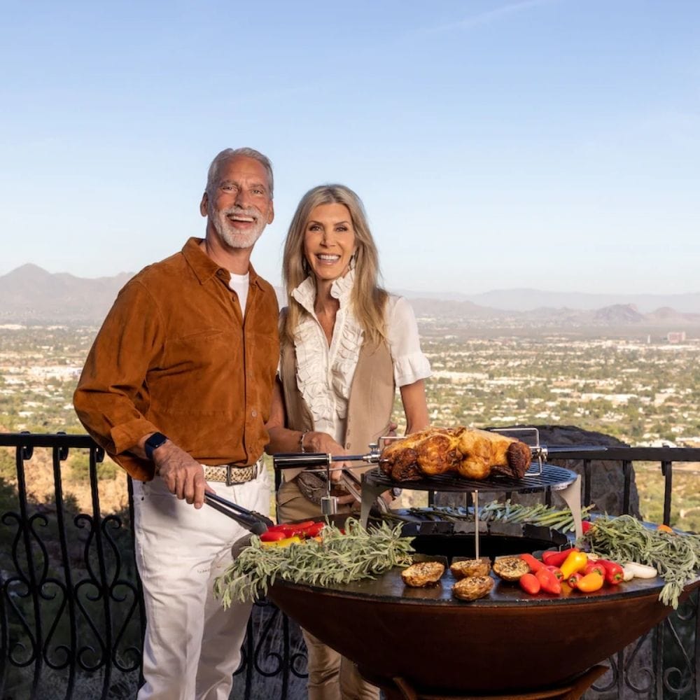 Cooking a family meal on a Arteflame 20-Inch Tall Euro Base Fire Pit with Cooktop
