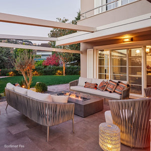 ecosmart fire wharf gray fire pit table in a garden