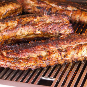 perfectly juicy seared steaks on diamond cooking grids