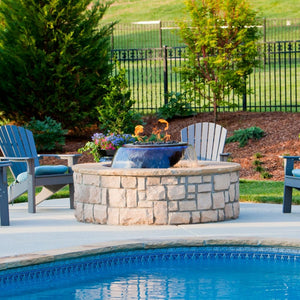 HPC Evolution 360 Copper Gas Fire and Water Bowl in a brick enclosure by the pool