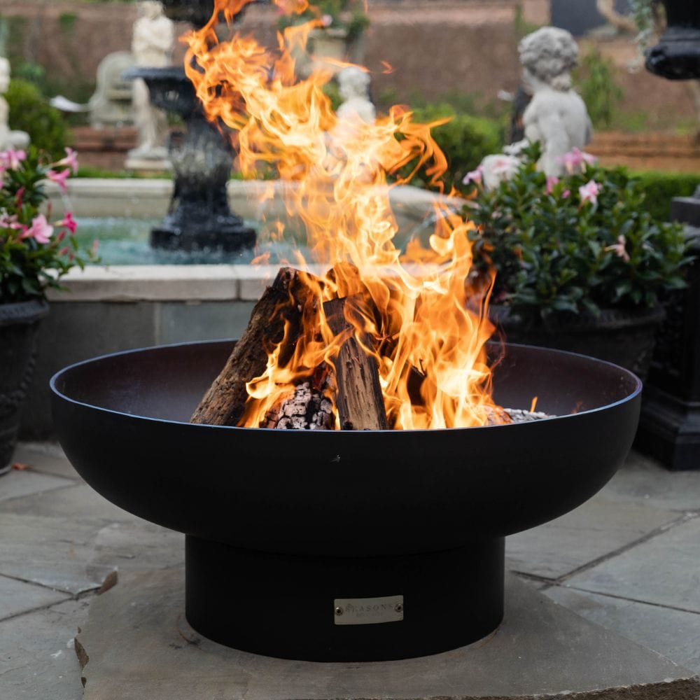 seasons fire pits elliptical steel fire pit near a fountain