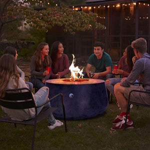 Gathering friends around the Stonelum Indiana 01 47-Inch Round Graphite Gas Fire Pit