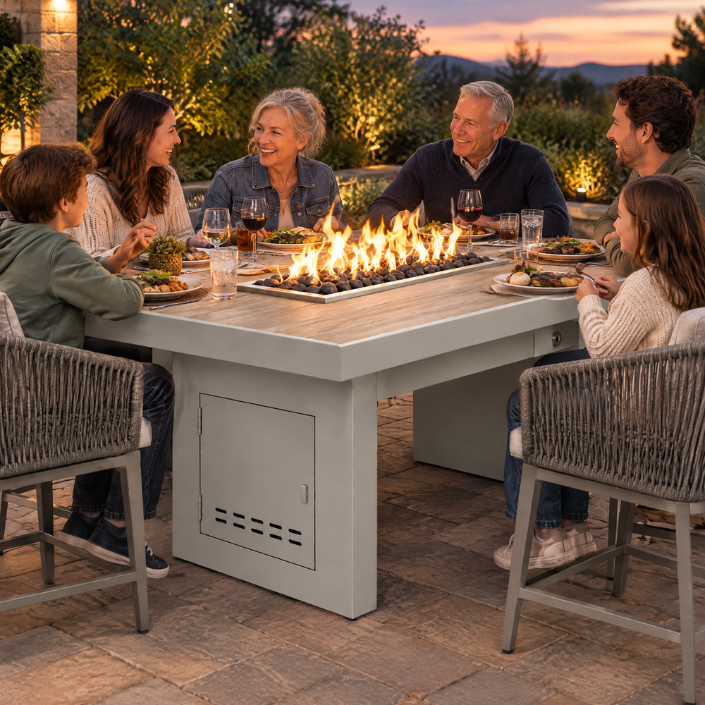 Family enjoying an evening meal around a Top Fires Alameda 72-inch composite wood gas fire table with a Summit tabletop and White base