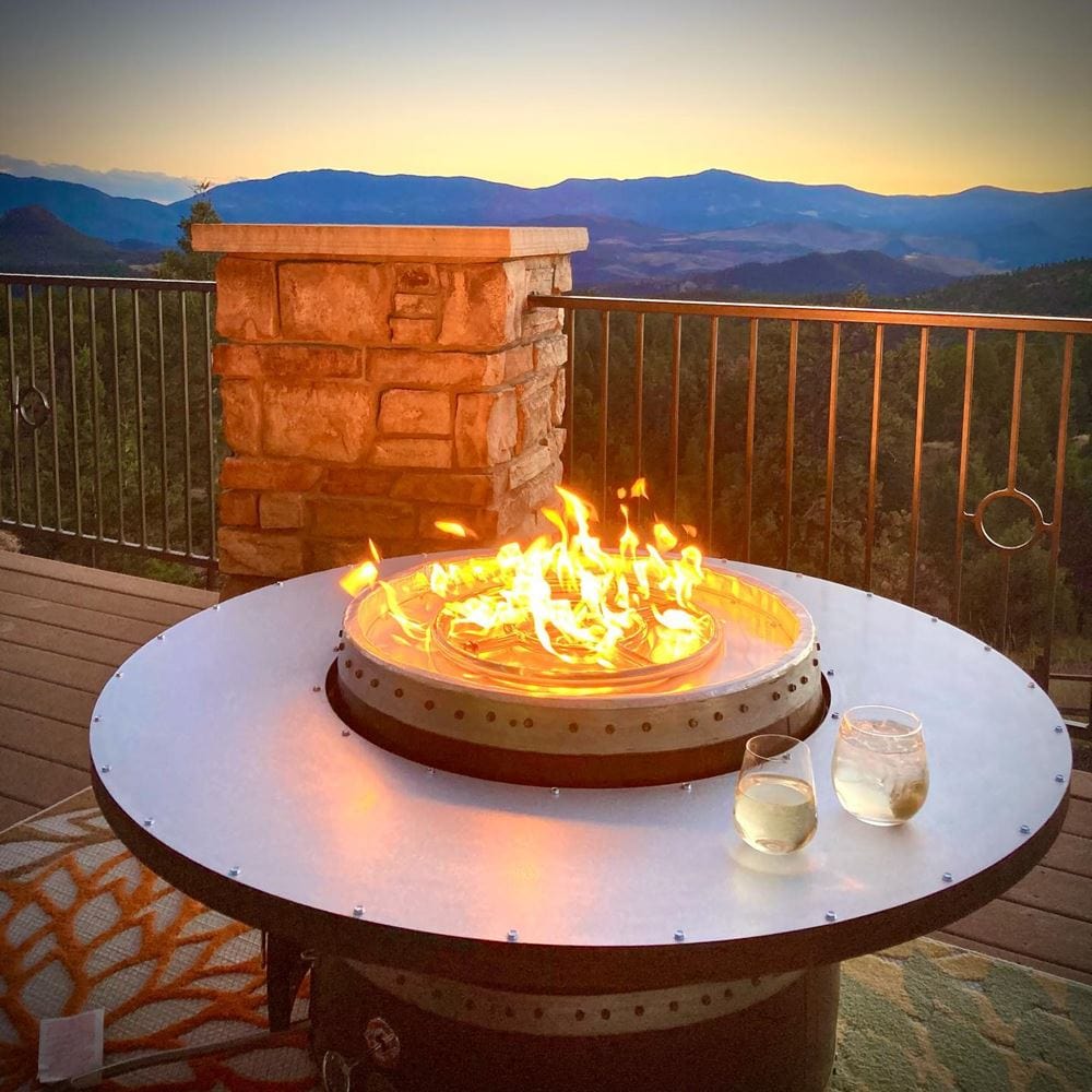 enjoying a glass of white wine by the wine barrel dude coffee table gas fire pit table