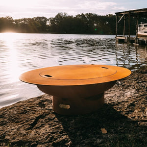 Fire Pit Art Magnum 54-Inch Handcrafted Carbon Steel Gas Fire Pit with Lid by the Docks