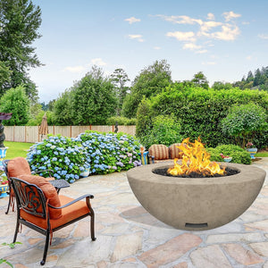 modern blaze round bone fire bowl with textured surface in a lush garden