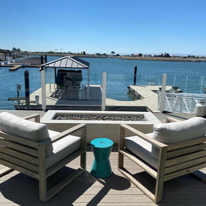 white linear gas fire pit table by the lake