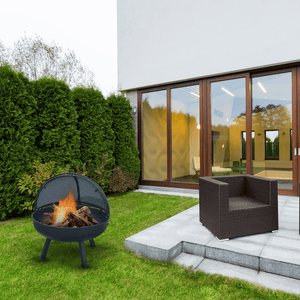 modern blaze round tripod base steel fire pit in a garden