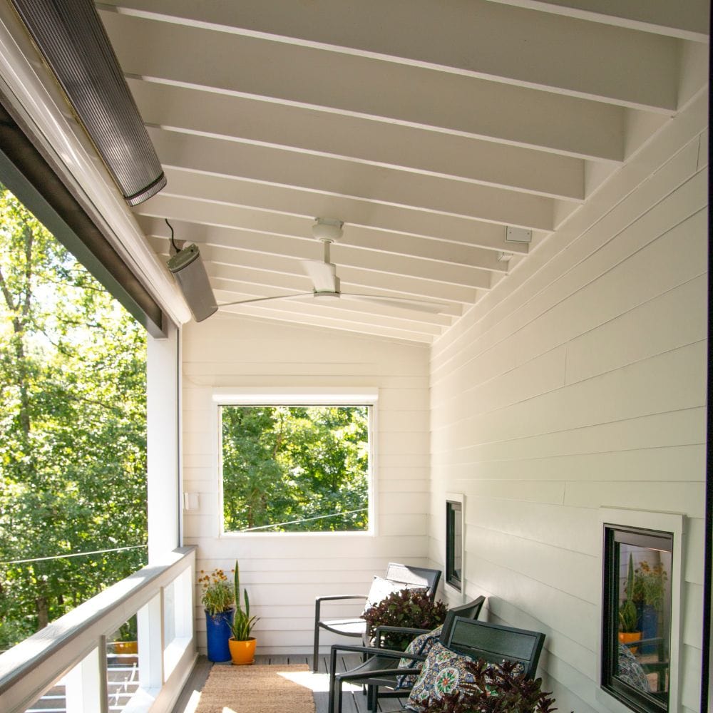 2 radtec design/e series infrared electric heaters ceiling mounted on a terrace - lifestyle view