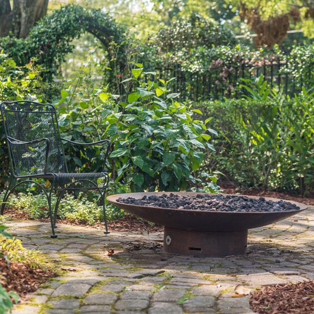 Seasons Fire Pits Concave Round Steel Fire Pit in the Garden - room setting