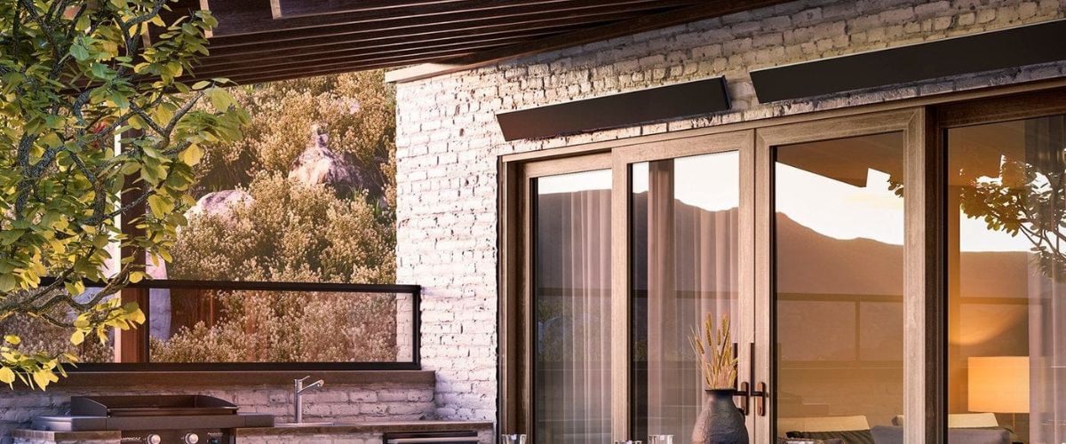 Sleek patio heaters mounted on a wall in a rustic outdoor dining area