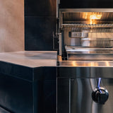 American Made Grills Estate 30 Gas Grill built into a tiled counter