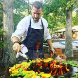 Grilling vegetables on the Arteflame 20" Tall Euro Base Corten Steel Fire Pit with Cooktop