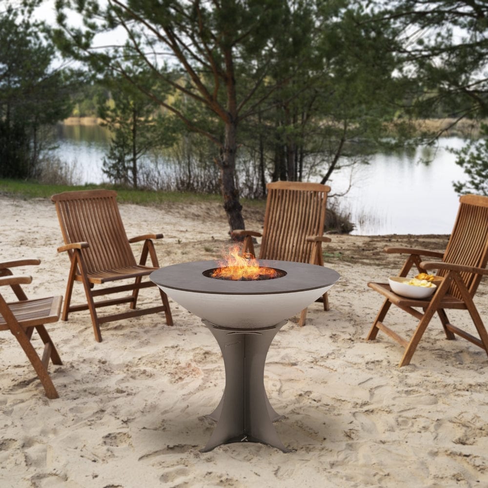 arteflame platinum grill with eurobase on sand with seats around it