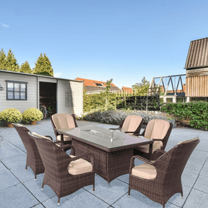 Direct Wicker Regal 7-Piece Outdoor Dining Set with LP Fire Pit Table (PAG-1106-R) in front of Garden Shed