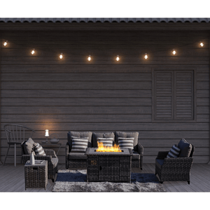 Direct Wicker Trinity 5-Piece Outdoor Furniture Set with LP Fire Pit Table (PAF-1802-New) outside on a Log Cabin deck in the evening