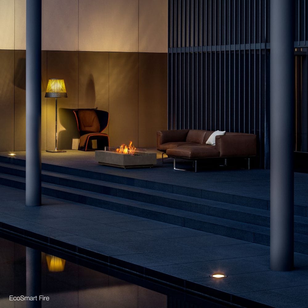 EcoSmart Fire Cosmo 50-Inch Rectangular Fire Pit Table in a patio overlooking the pool