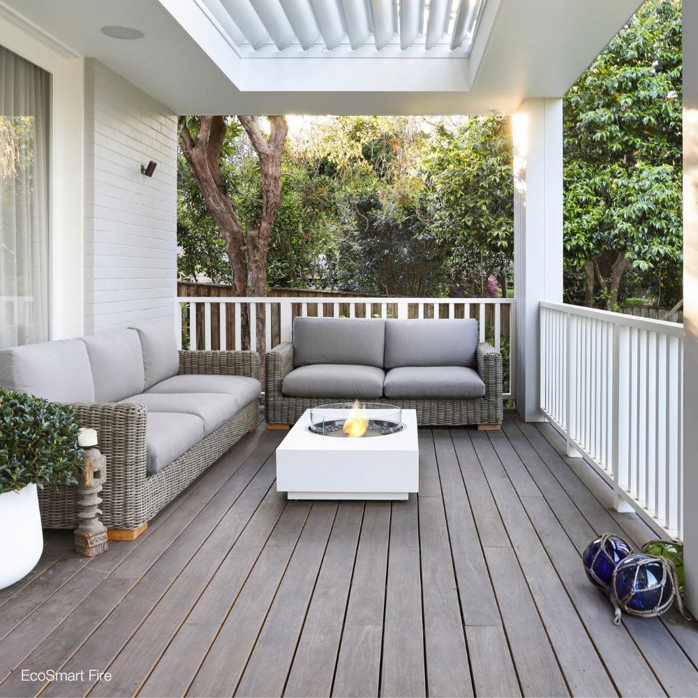 EcoSmart Fire Martini 50-Inch Rectangular White Fire Pit Table on a patio deck