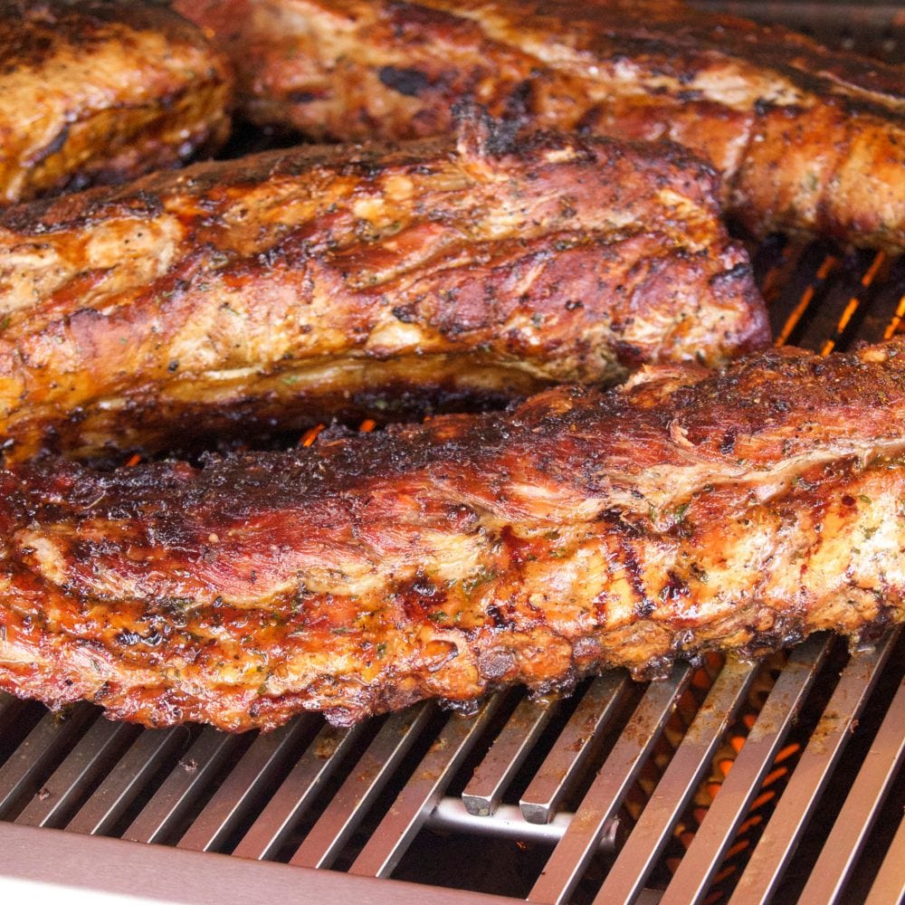 perfectly juicy seared steaks on diamond cooking grids