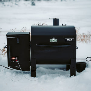 Green Mountain Grills Trek Prime 2.0 Pellet Grill being use in snowfield outdoor