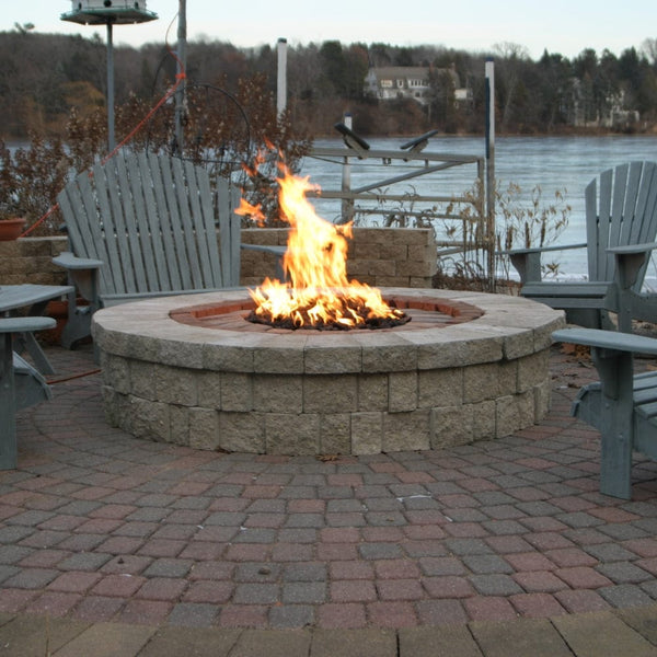 HPC Round Flat Standard Gas Fire Pit Insert in a low round fire pit by the lake - side view
