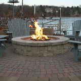 HPC Round Flat Standard Gas Fire Pit Insert in a low round fire pit by the lake - side view
