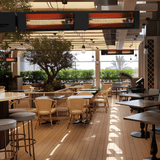 King Electric SmartWave Infrared Radiant Patio Heaters are installed at a commercial lounge. - side view