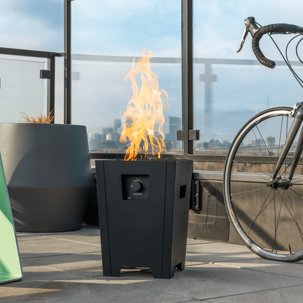 Live Outdoor Firestorm Series I Free Standing Fire Pit with Burner On on the Outdoor Patio