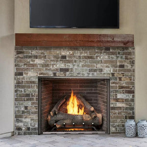 majestic courtyard fireplace with brick interiors and a beautiful wood mantel