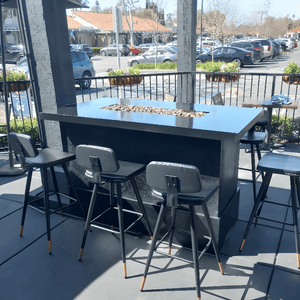 Modern Blaze Aleutians Fire Pit Table on a restaurant's patio