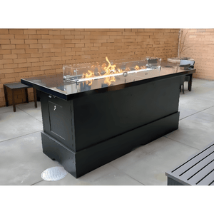 Modern Blaze Aleutians Fire Pit Table in an outdoor space with burner turned on