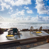 modern blaze wok off white gas fire bowl on a beautiful patio overlooking the beach
