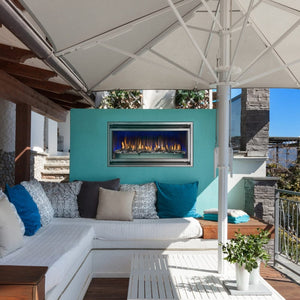 Montigo Mahana PL42VO Outdoor Fireplace built into a teal wall