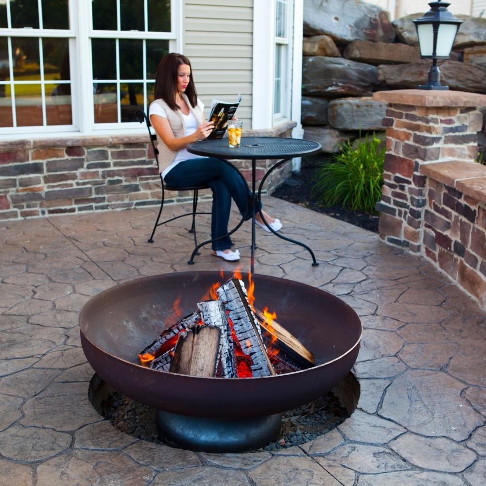 Woman Reading by Fire Pit