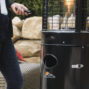 Turning on the Paragon Outdoor Helios Round Propane Patio Heater in Black with a remote