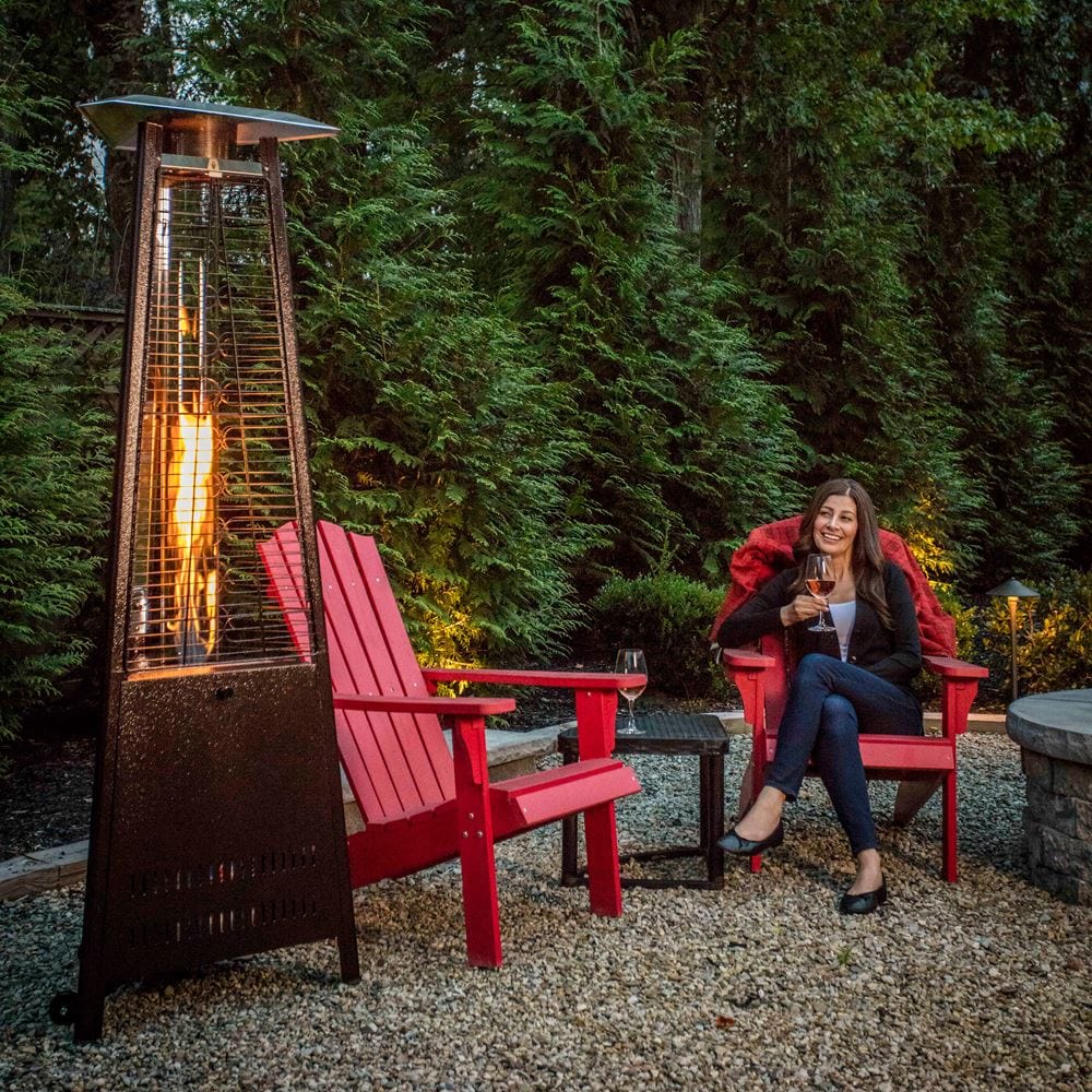 Paragon Outdoor Inferno Flame Tower Patio Heater with a couple of seats beside it