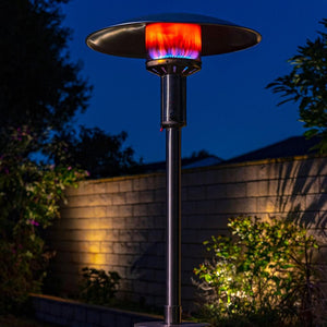 patio comfort jet silver propane patio heater in a garden at night