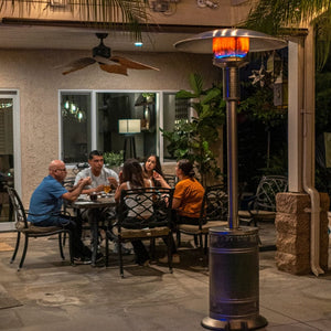 patio comfort npc05ss stainless steel gas patio heater near a family enjoying dinner