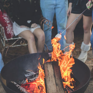 roasting marshmallow on the seasons fire pits elliptical steel fire pit