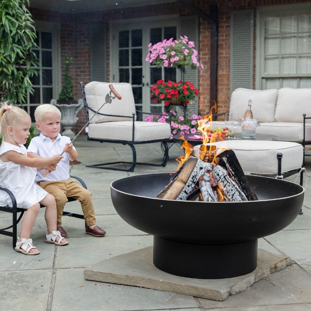 roasting hotdogs on the seasons fire pits elliptical steel fire pit