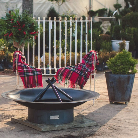 Seasons Fire Pits Flare Round Steel Fire Pit on top of a paver