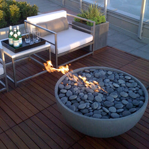 a full bed of solus river stones on the hemi gas fire pit