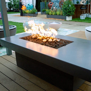 Solus Tavolo 68-Inch Linear Concrete Gas Fire Pit in a cozy outdoor space