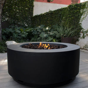 stonelum coliseo 1 round black fire pit in a lush outdoor space