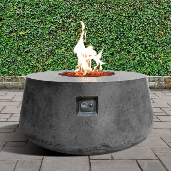 Stonelum Indiana 01 47-Inch Round Graphite Gas Fire Pit in a garden