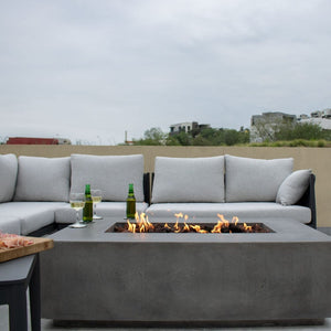 Stonelum Manhattan 01 Rectangular Graphite Fire Pit Table with beer and wine on the ledge