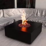 stonelum praga 1 square black gas fire pit with chairs around it