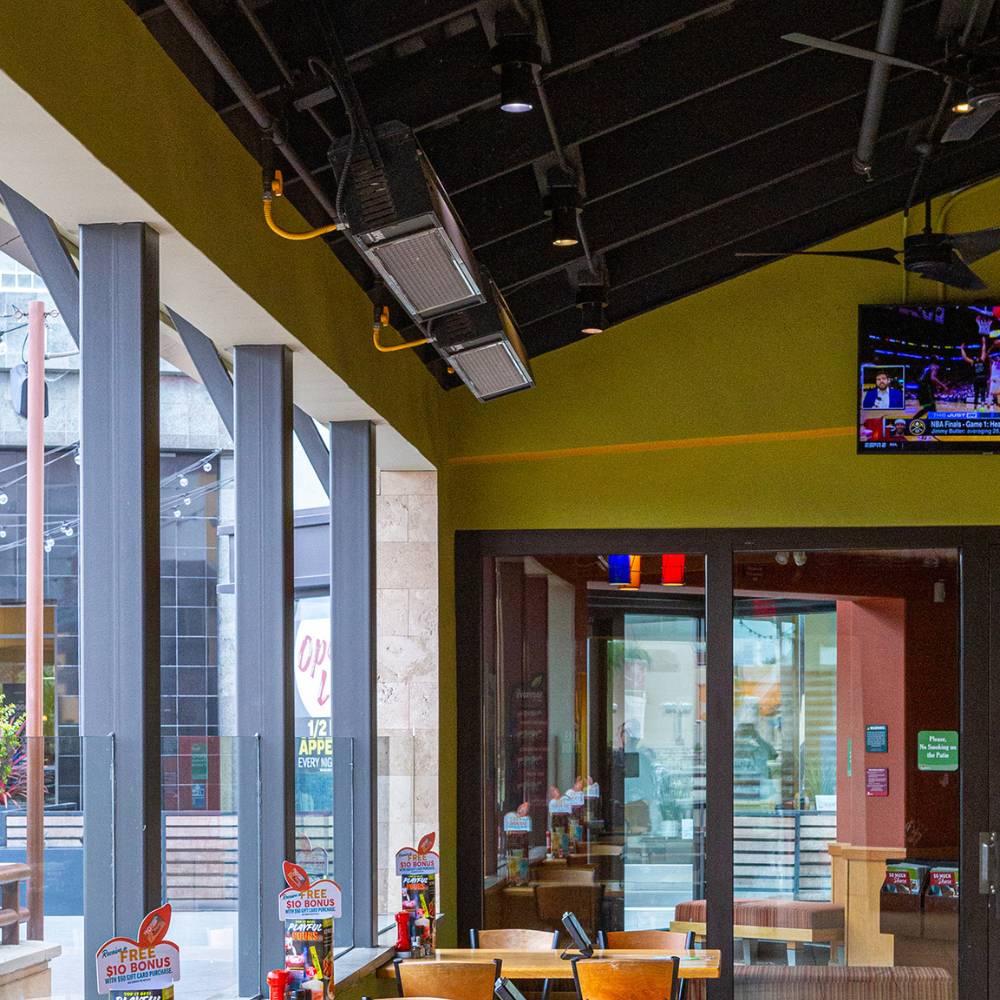 Sunpak S25 Wall/Ceiling Mounted Black Infrared Gas Heater on a restaurant's patio - installation view