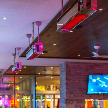 sunpak s25 stainless steel infrared gas patio heaters at a bar - side view